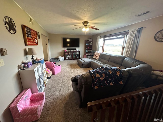 carpeted living room with a textured ceiling and ceiling fan