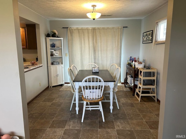 dining room with a textured ceiling