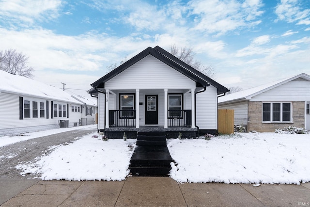 bungalow featuring a porch and central AC unit