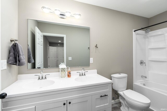 full bathroom with vanity, toilet, and shower / washtub combination