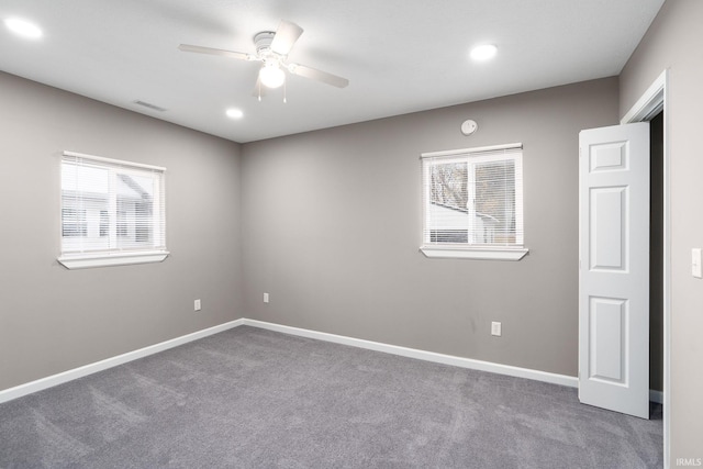 carpeted empty room featuring ceiling fan