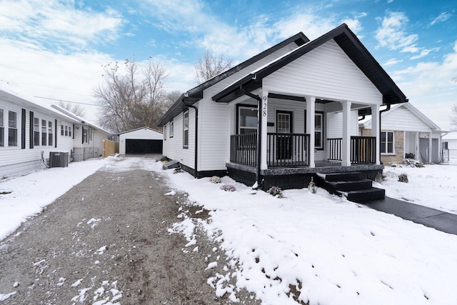 view of front of property with cooling unit, covered porch, an outdoor structure, and a garage