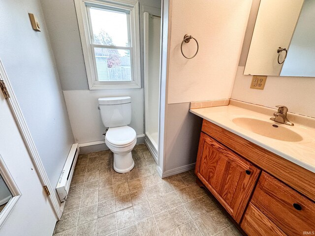 bathroom with vanity, toilet, a shower, and a baseboard radiator