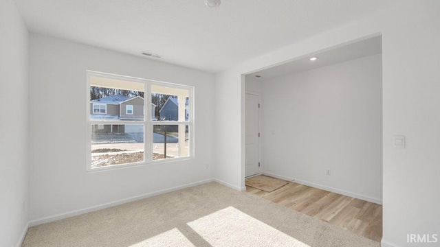 unfurnished room with light hardwood / wood-style flooring