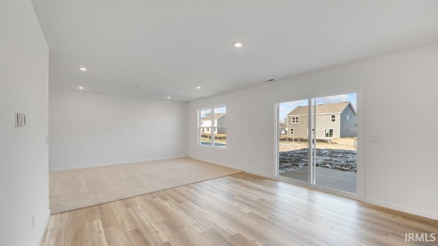 unfurnished room with light hardwood / wood-style floors