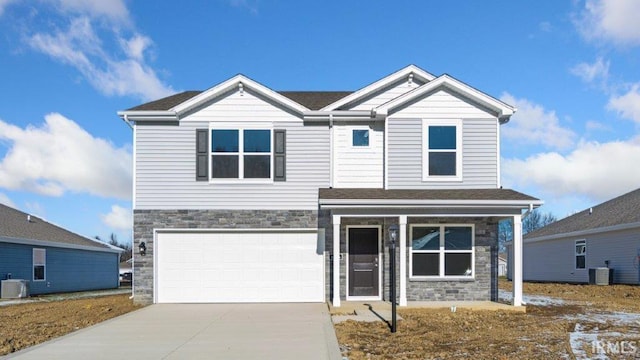 view of front of property with central AC and a garage