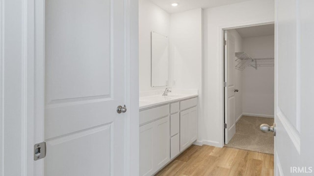 bathroom featuring vanity and hardwood / wood-style flooring