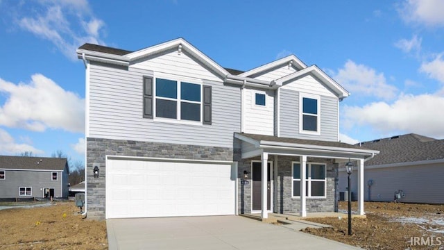 view of front of property featuring covered porch and a garage