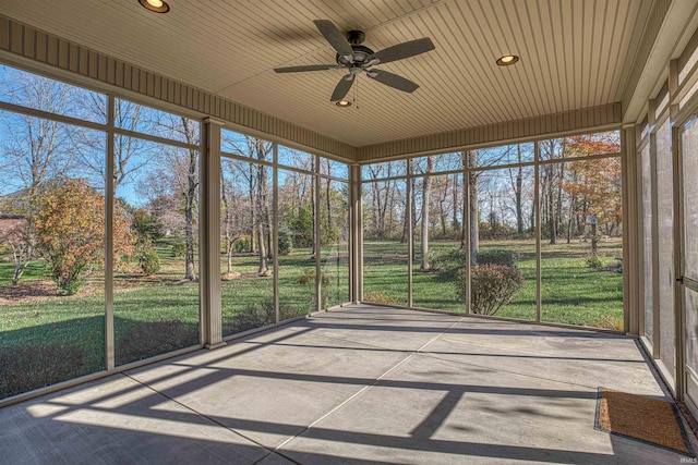 unfurnished sunroom featuring ceiling fan and wood ceiling