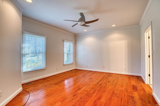 empty room with ceiling fan, crown molding, and light hardwood / wood-style flooring