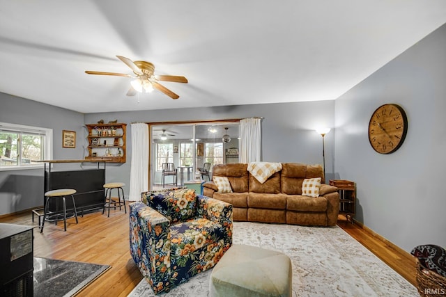 living room featuring hardwood / wood-style floors and ceiling fan