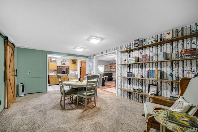 carpeted dining space featuring a barn door