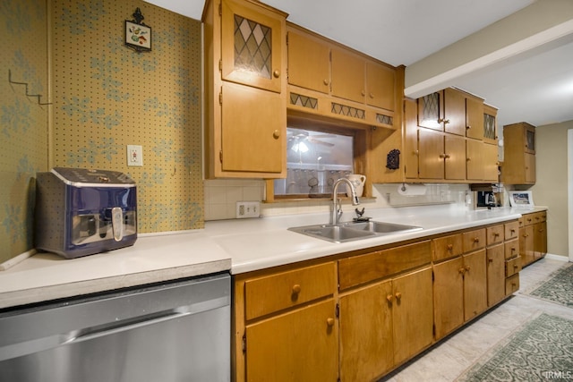 kitchen with backsplash, sink, light tile patterned floors, and stainless steel dishwasher