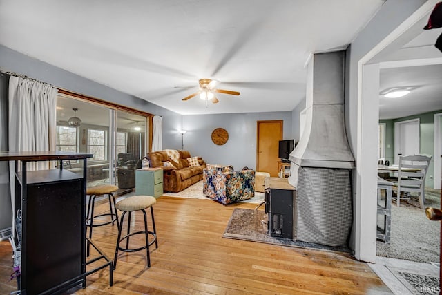 living room featuring light hardwood / wood-style flooring and ceiling fan