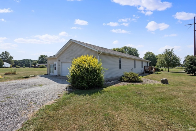 view of home's exterior with a yard and a garage