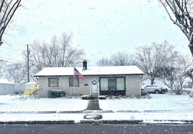 view of front of home featuring a shed