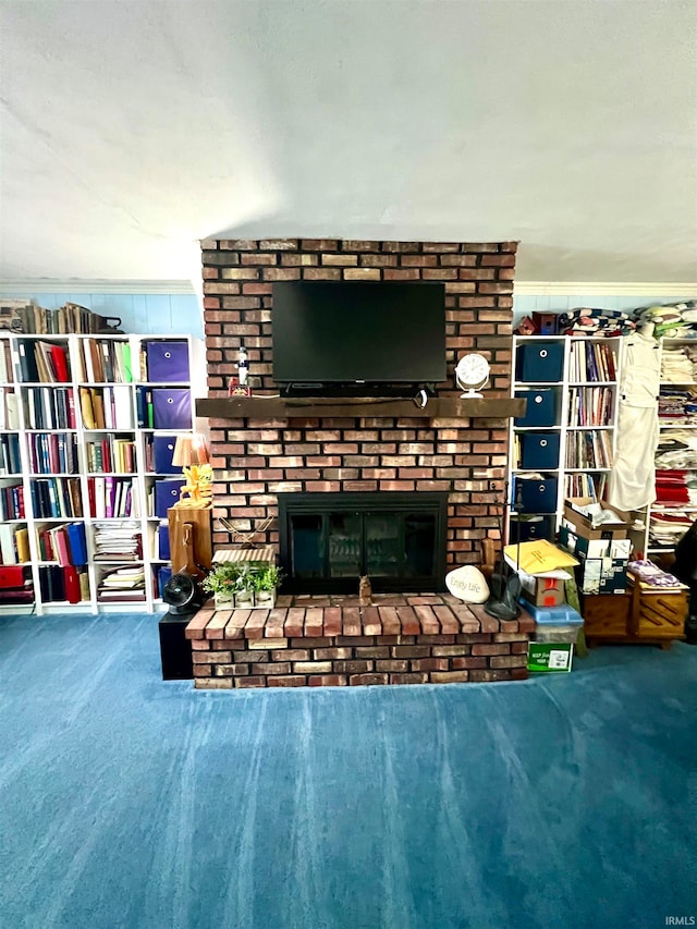 carpeted living room with a brick fireplace and ornamental molding