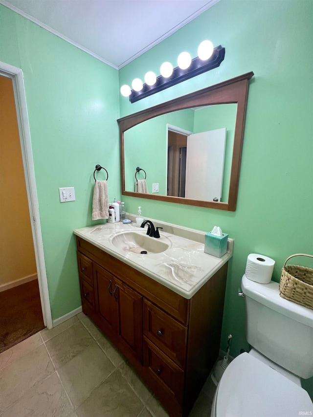 bathroom with tile patterned flooring, vanity, and toilet