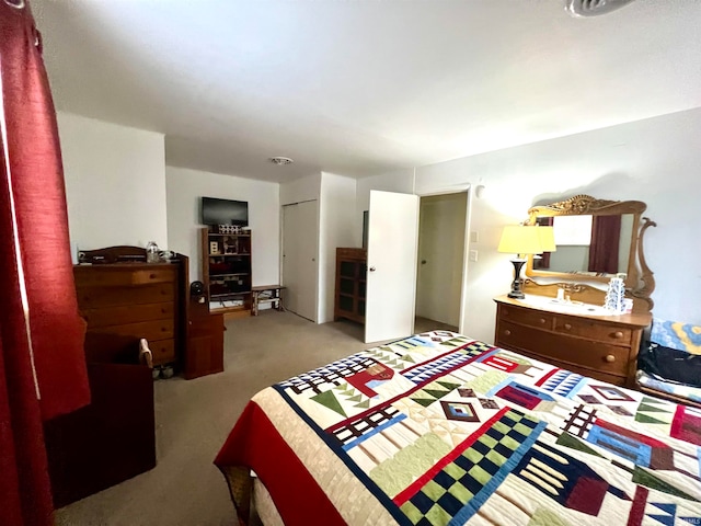 carpeted bedroom with a closet