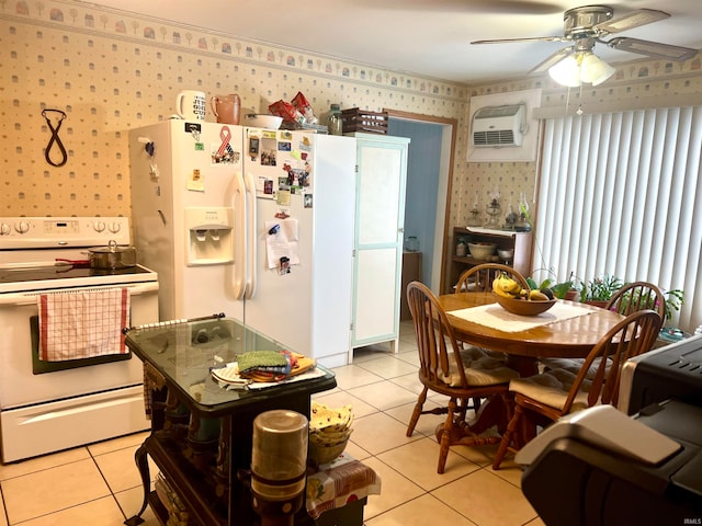 kitchen with light tile patterned floors, white appliances, a wall unit AC, and ceiling fan