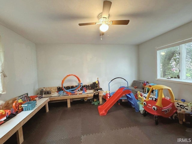 game room with carpet flooring and ceiling fan