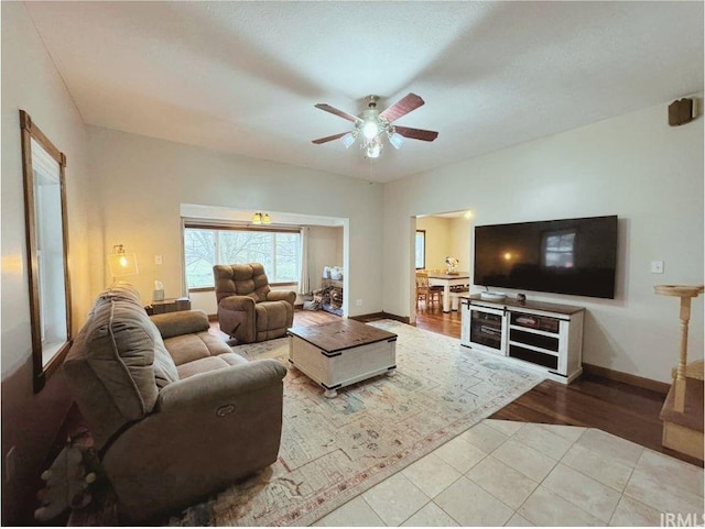 living room featuring ceiling fan and light wood-type flooring