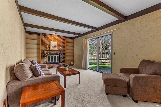 living room with light carpet, beamed ceiling, a textured ceiling, and a brick fireplace