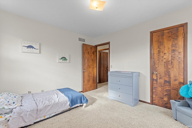 bedroom featuring light colored carpet