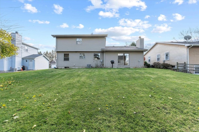 back of house featuring a lawn and cooling unit