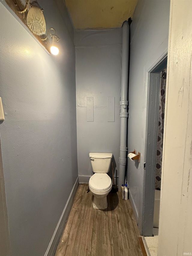 bathroom featuring wood-type flooring and toilet