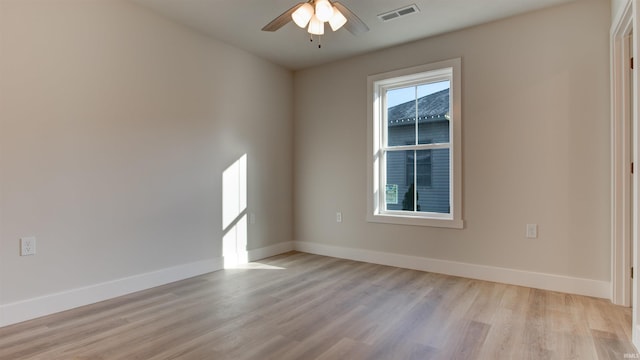 spare room with ceiling fan and light wood-type flooring