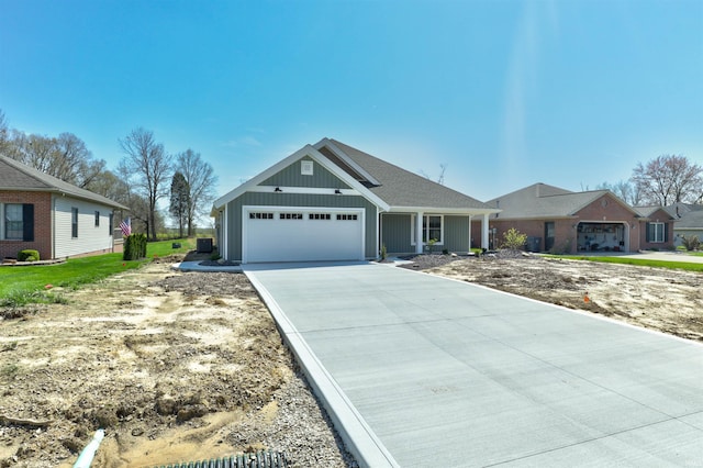 single story home featuring concrete driveway and an attached garage