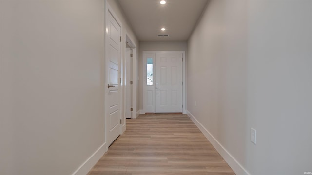 doorway to outside with light wood-type flooring