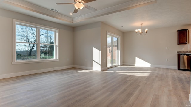 unfurnished living room featuring light wood-type flooring, crown molding, ceiling fan with notable chandelier, and a raised ceiling