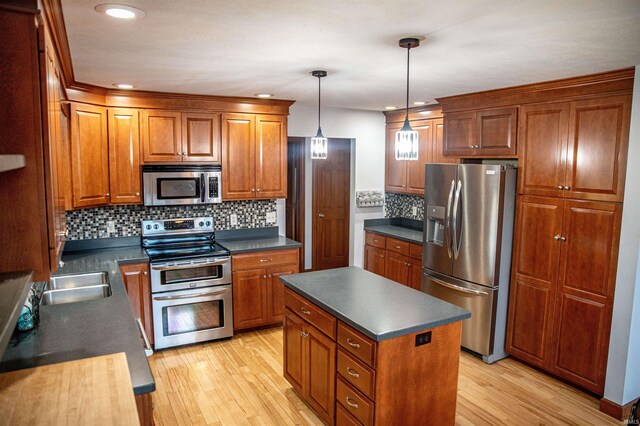 415 W 060 N, Lagrange, IN 46761 - kitchen with appliances with stainless steel finishes, dark countertops, brown cabinets, light wood-style flooring, and recessed lighting