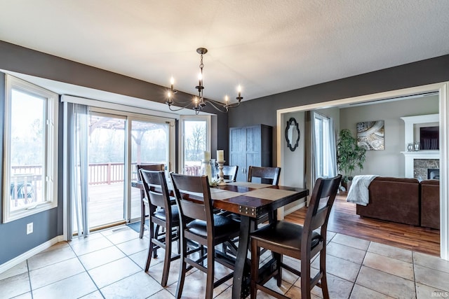 dining room featuring a notable chandelier, a textured ceiling, and light hardwood / wood-style flooring