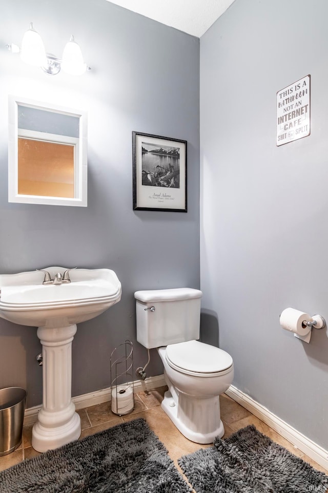 bathroom featuring tile patterned floors, sink, and toilet