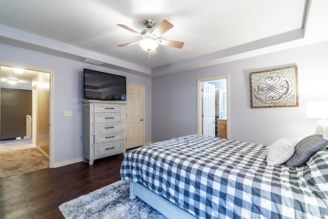 bedroom featuring ensuite bathroom, ceiling fan, and dark wood-type flooring