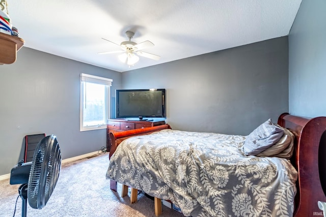 bedroom with a textured ceiling, carpet floors, and ceiling fan