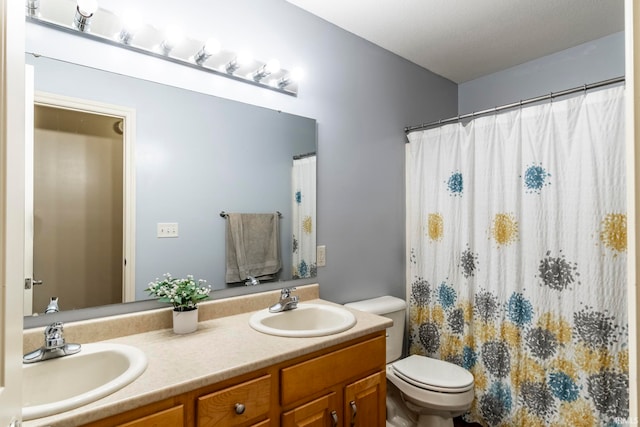 bathroom with vanity, toilet, and walk in shower