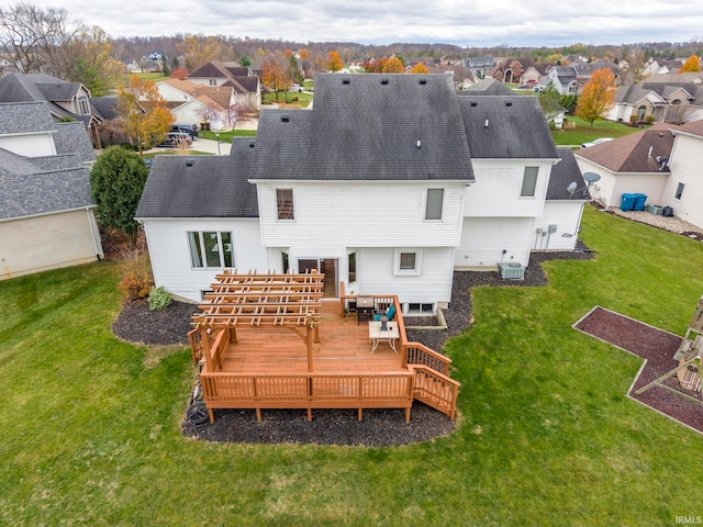 back of house with a lawn, cooling unit, and a deck