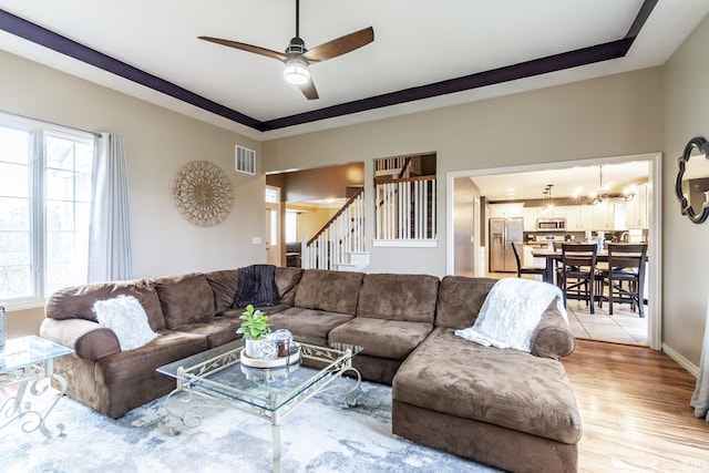 10229 Consta Verde Commons, Leo, IN 46765 - living room with stairway, a ceiling fan, wood finished floors, a chandelier, and baseboards