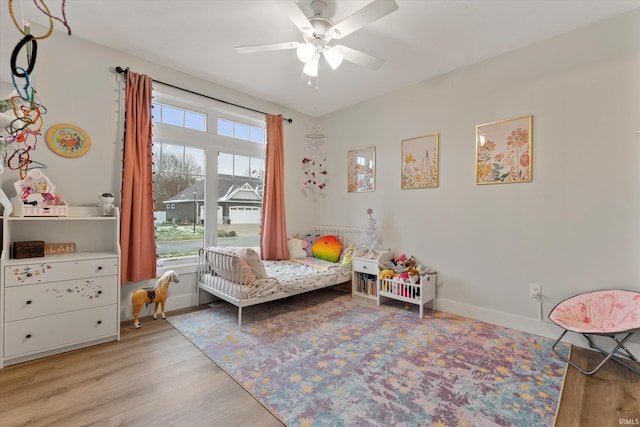 bedroom featuring light hardwood / wood-style floors and ceiling fan