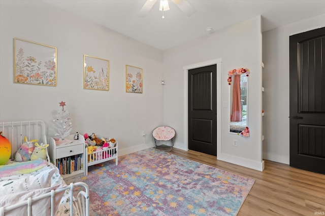 bedroom featuring light wood-type flooring and ceiling fan