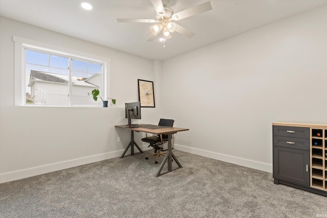 carpeted office space with ceiling fan