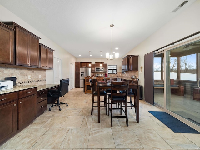 dining space with a notable chandelier