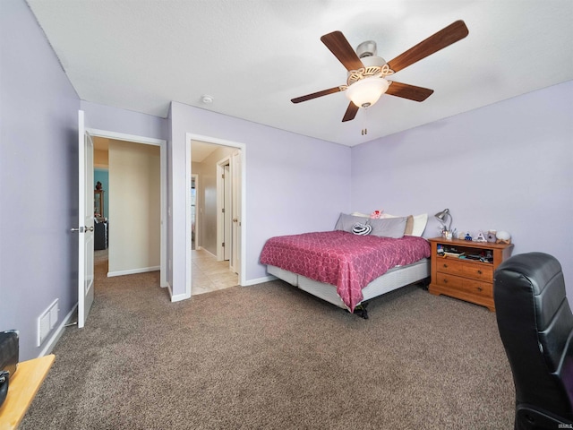 bedroom with ceiling fan and light carpet