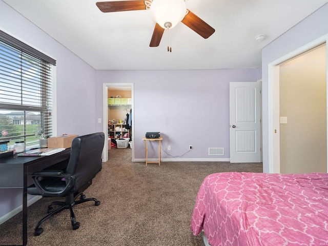 carpeted bedroom featuring a closet, a spacious closet, and ceiling fan