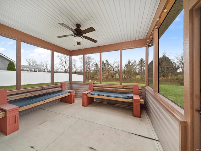 unfurnished sunroom featuring ceiling fan