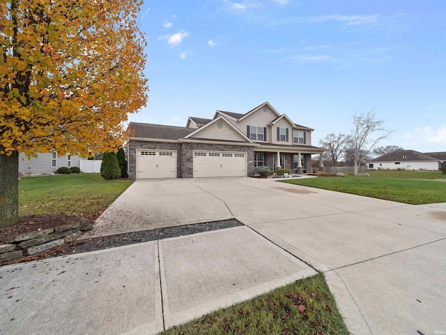 view of front of house featuring a garage and a front lawn